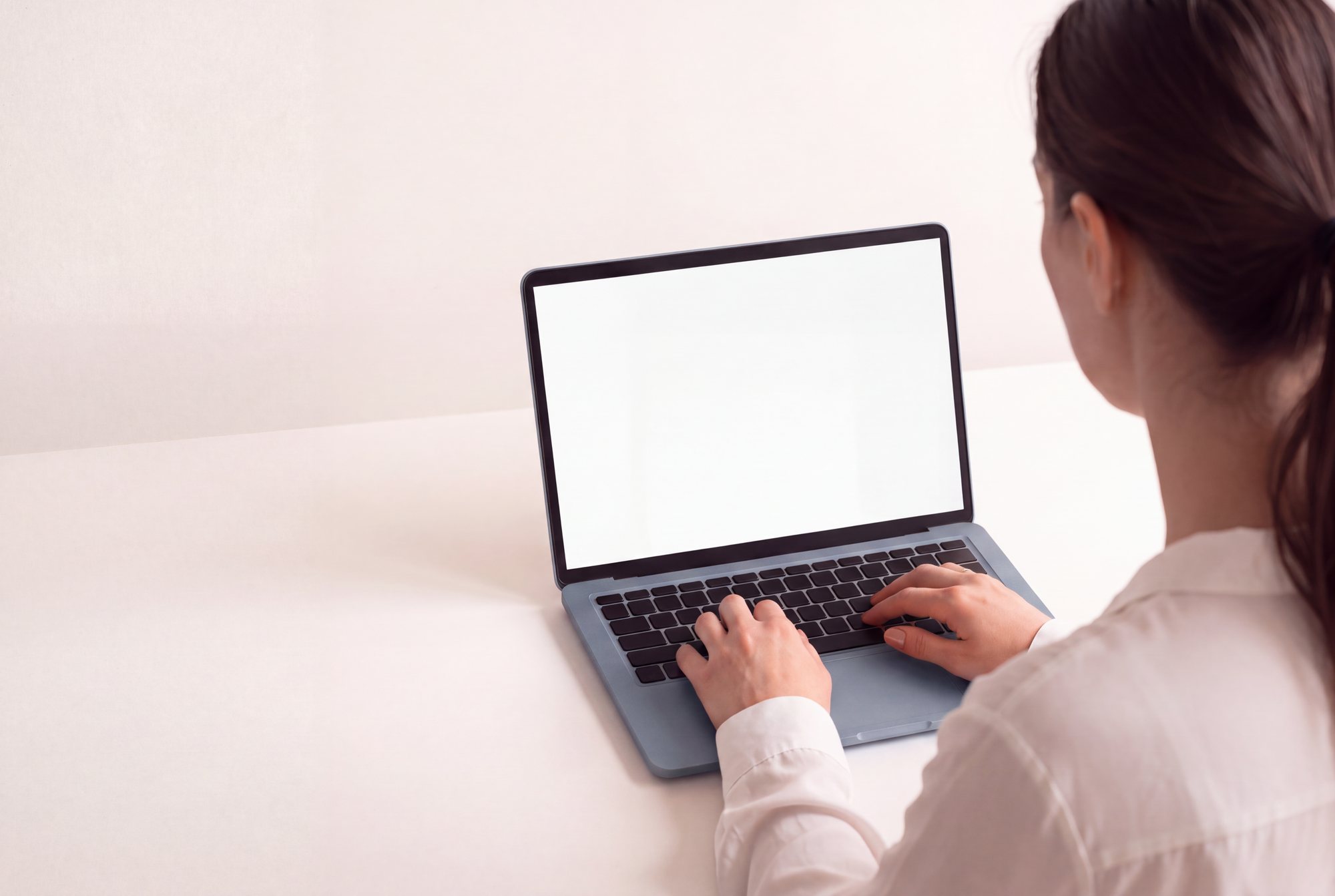 A woman working on a laptop in her HR system
